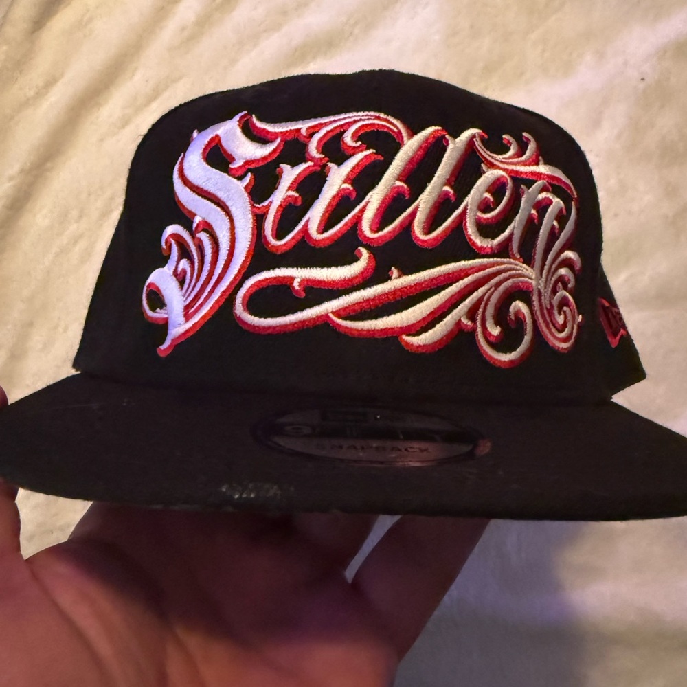 Sullen black and red SnapBack hat with roses and chains graphic on the brim